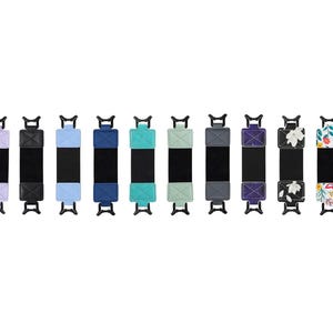 May include: Ten different colored and patterned wrist straps with black adjustable closures. The straps are made of fabric and have a variety of designs, including floral, geometric, and solid colors.