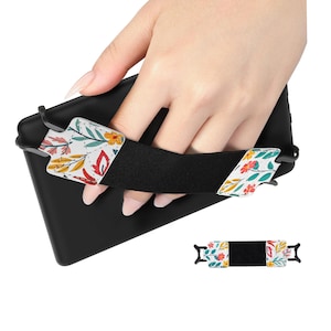 May include: A black phone case with a floral print strap. The strap is adjustable and has a secure grip.