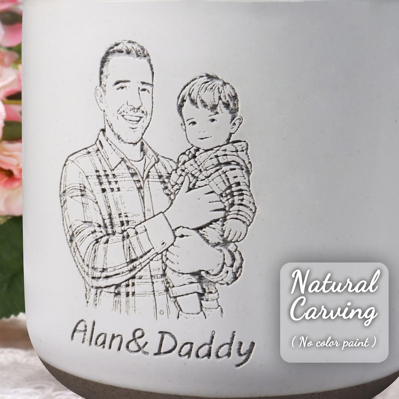 May include: A white ceramic mug with a detailed engraved portrait of a father and child. The text "Alan & Daddy" is below the portrait. The mug also features the text "Natural Carving (No color paint)".