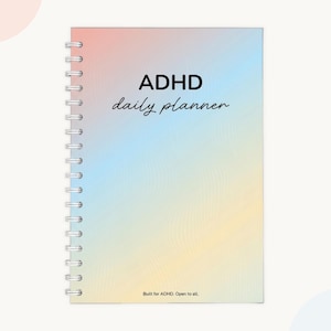 ADHD daily planner for adults, undated day planner with rainbow gradient cover — wire bound planner reading "Built for ADHD. Open to all," adhd organization planner for focus