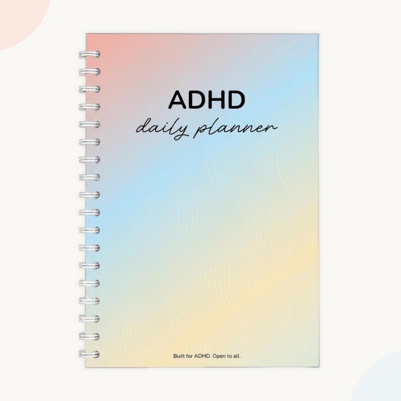 ADHD daily planner for adults, undated day planner with rainbow gradient cover — wire bound planner reading "Built for ADHD. Open to all," adhd organization planner for focus