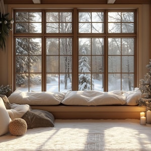 May include: A cozy interior scene with a large window overlooking a snowy forest. The window seat is adorned with plush white pillows and a decorative woven ball. A small Christmas tree and lit candles add to the festive atmosphere.