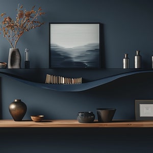 May include: A dark blue wall with a curved black shelf holding a variety of decorative items, including vases, books, and artwork. The shelf is mounted above a wooden shelf with a gold vase, a wooden bowl, and a black bowl.