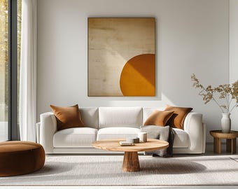 May include: A white sofa with brown throw pillows sits in a living room with a wooden coffee table and a side table. A large abstract painting with a yellow and brown color scheme hangs on the wall behind the sofa.