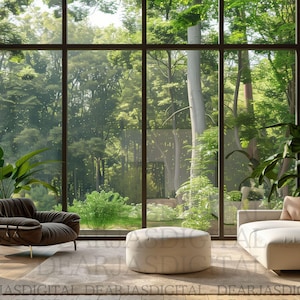 May include: A modern living room with a large window overlooking a lush green forest. The room features a brown armchair, a white sofa, and a round ottoman. Large green plants add to the natural aesthetic. The room has a light, airy feel.