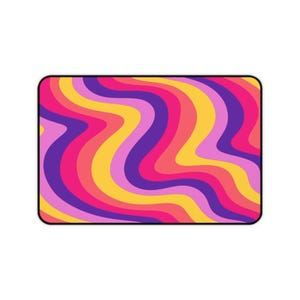 May include: Abstract wavy pattern with purple, pink, yellow, and orange stripes. The background is white.
