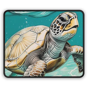 May include: A square mousepad with a detailed illustration of a sea turtle swimming underwater. The turtle has a tan shell with a geometric pattern, a yellow head, and dark eyes. The background is a teal colour with bubbles.