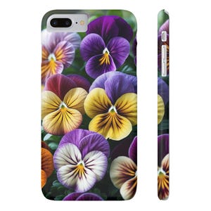 May include: A phone case featuring a vibrant floral design of pansies in shades of purple, yellow, and white. The case wraps around the phone, with a matching design on the side. The flowers are in full bloom, creating a colorful and detailed pattern.
