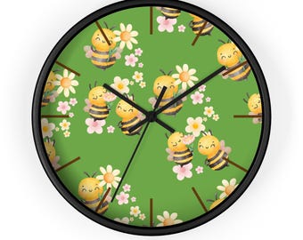 May include: A round wall clock with a black frame. The clock face is green and features a repeating pattern of cartoon bees, white daisies, and pink flowers. The clock hands are black.
