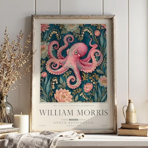 May include: A framed poster featuring a pink octopus centred against a dark teal background with floral patterns. The text reads 1861 COTTON TEXTILES EXHIBITION, WILLIAM MORRIS, NEAREST STATION SOUTH KENSINGTON, LONDON, ENGLAND, ADMISSION FREE.