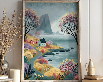 May include: A framed wall art print depicting a coastal landscape with a small house, a winding path, colorful foliage, and a large mountain in the background. The scene features a blue sea, dark rocks, and trees with yellow and pink blossoms under a cloudy sky.