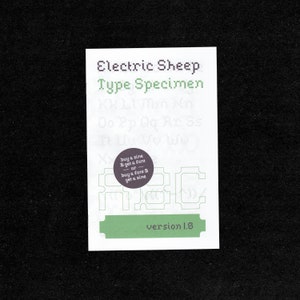 May include: A white card with the text "Electric Sheep Type Specimen" in pixelated font. The card also features sample letters, a purple circular graphic, and the text "version 1.8" in green.