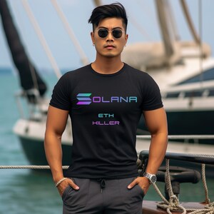 Può includere: Una maglietta nera con una grafica colorata della parola "SOLANA" e il testo "ETH KILLER" sotto.