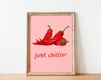 May include: A framed print with a pink background featuring three red chili peppers and the text "just chillin'" in red.