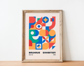 May include: A framed poster featuring a geometric design in red, blue, yellow, green and white. The poster reads "Bauhaus Exhibition" with the dates "July 24" and "1919".