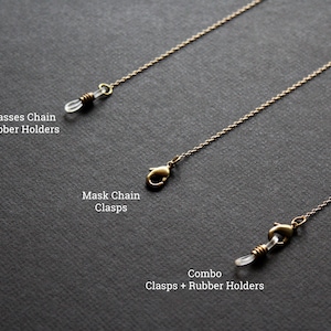 May include: Three gold chains with different ends. The top chain has clear rubber holders, the middle chain has a gold clasp, and the bottom chain has a gold clasp and clear rubber holders. The chains are labeled "Glasses Chain Rubber Holders", "Mask Chain Clasps", and "Combo Clasps + Rubber Holders".