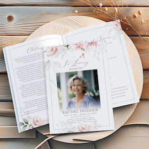 May include: A memorial service program with a photo of Rachel Hodder, framed by floral accents. The program includes the obituary, service details, and a photo. The design features soft colors and elegant typography, suitable for a funeral or memorial.