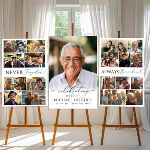 May include: Three vertical memorial posters displayed on wooden easels. The center poster features a large portrait of a smiling man with the text "celebrating THE LIFE OF MICHAEL HODDER 17 JULY, 1957 - 21 AUGUST, 20XX". Flanking posters show photo collages.