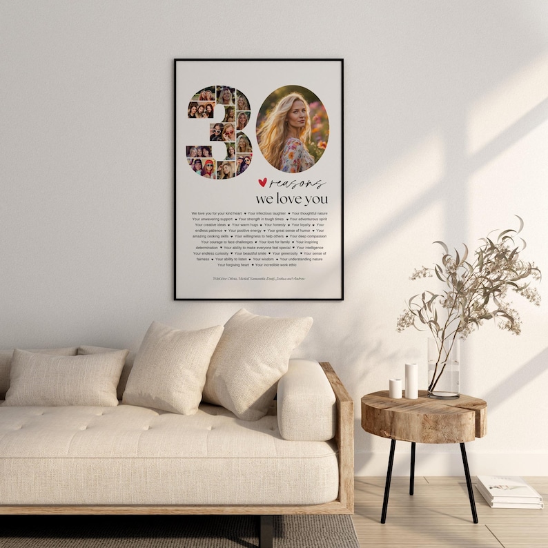 May include: A framed print with the text "30 reasons we love you." The number 30 is composed of multiple small photos. A photo of a woman is on the right. The print is displayed above a beige sofa and a wooden side table.