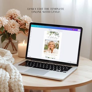 May include: A laptop displaying a funeral program template on a Canva interface. The screen shows a memorial card with the text Celebrating the life of Barbara Hodder, featuring a photograph of a woman and green botanical leaf illustrations.