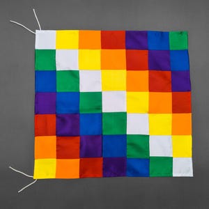 May include: A colorful checkered flag with alternating squares of red, orange, yellow, green, blue, purple, and white.