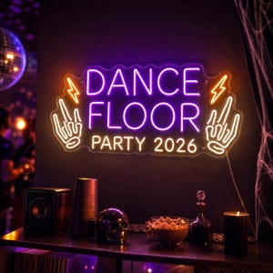 May include: A rectangular neon sign with wavy edges displaying the text DANCE FLOOR PARTY 2026 in purple and white. The sign features orange lightning bolt icons and white hand gestures in a rock-and-roll style on the left and right sides.