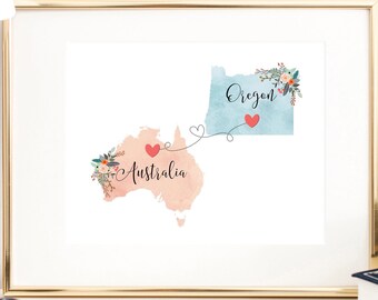 May include: A framed print with a watercolor map of Oregon and Australia connected by a dotted line with hearts. The text "Oregon" and "Australia" are written on the maps.