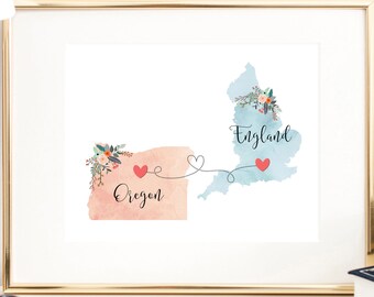May include: A watercolor print of a map of Oregon connected to a map of England with a red heart and a line. The text "Oregon" and "England" are written on the maps.