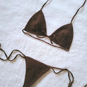 Può includere: Un set di bikini in crochet marrone con un top a triangolo e uno slip a vita alta.