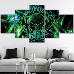 May include: A five-panel canvas art piece featuring a neon green and blue skull design against a black background. The artwork has a modern, abstract style, with swirling lines and shapes. The panels are arranged above a white sofa.
