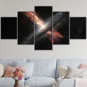 May include: A five-piece canvas print set featuring a colorful nebula in a dark space background. The nebula is a swirling mass of red, orange, and yellow, with a white center. The background is black with scattered stars.