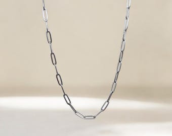 May include: A silver chain necklace with a simple, linked design.