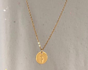 May include: A gold chain necklace with a small round pendant that says "Faith" with a cross above the word.