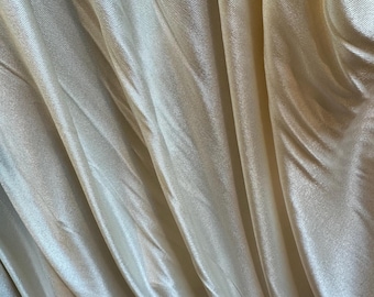 Rayon jersey knit in a pale shade of ivory.  Exquisite drape and hand. Lovely sheen.