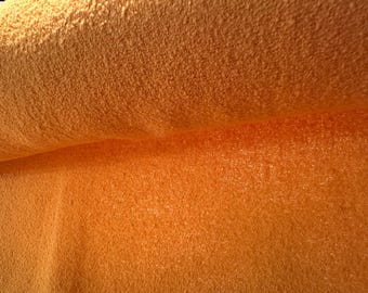 Wool knit boucle’ fabric in a vibrant shade of saffron.