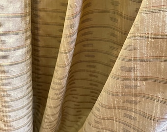Silk dupioni, hand woven, spaced plaid and ikat design on a cornsilk colored background. Textured surface.  Lustrous look.