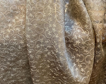Bronze hued, crisp silk organza; hand embroidered.