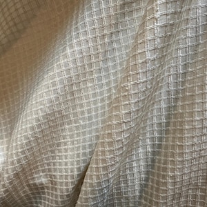 Silk organza, handwoven, tone on tone bright white grid pattern.