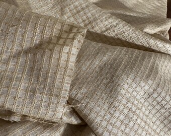 Crisp silk organza, hand woven in a soft shade of wheat.  Textured grid pattern.