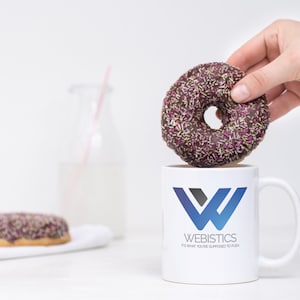 Chocolate sprinkle donut held above Sopranos fan art mug with iconic Tony Soprano quote. A must-have for The Sopranos fans who love a coffee break with mob boss flair.