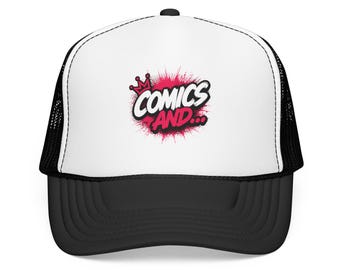 May include: A white and black trucker hat featuring a graphic print on the front panel. The design displays the text COMICS AND... in a bold white font with a pink crown icon above, set against a pink spray-paint style background effect.