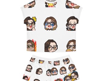 May include: A white short-sleeved t-shirt and matching shorts set featuring an all-over print of various chibi-style cartoon characters with dark hair and glasses, displaying different facial expressions and activities like eating popcorn or crying.