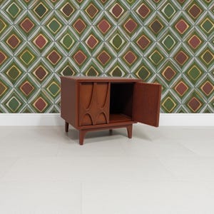 Nightstand shown with one door opened. Inside is storage space.