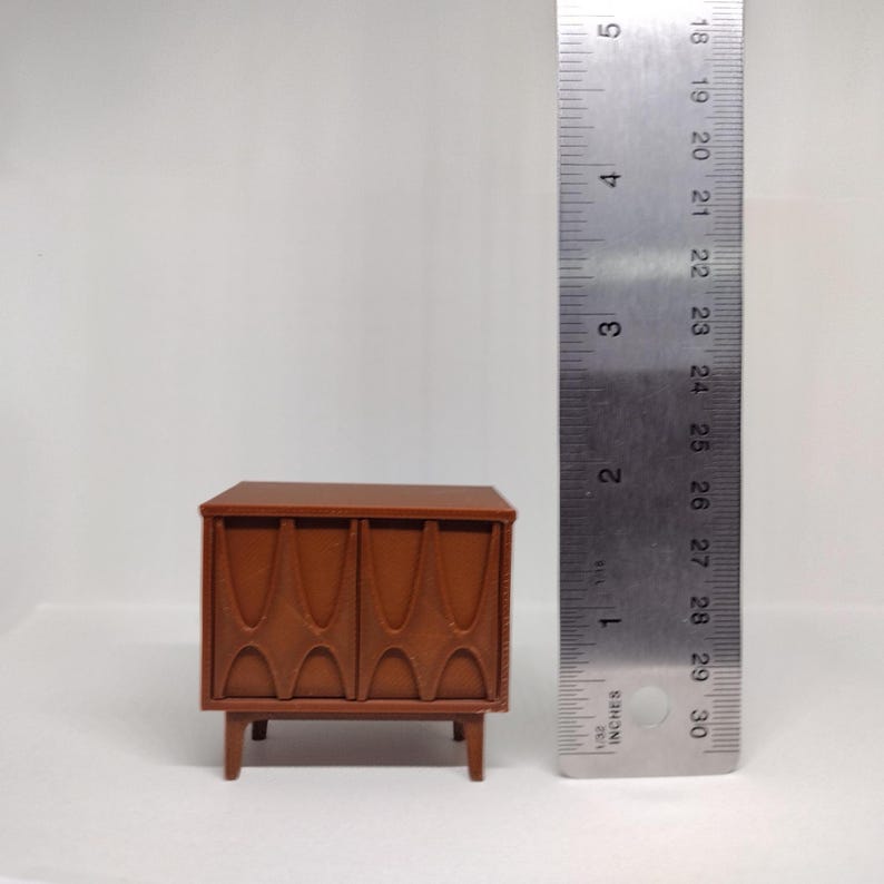 Dollhouse nightstand shown alongside a ruler.