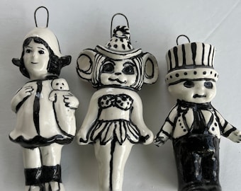 Three black and white wall dolls