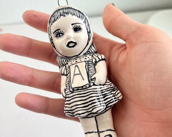 Black and white ceramic dolly with a scarf