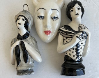 Two women and a bottle face wall decor