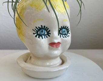 Tammy Faye doll head planter