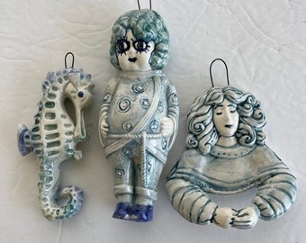 Three larger blue wall dolls