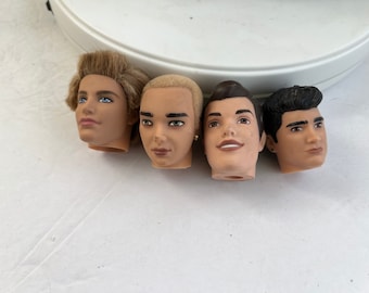 Four male doll heads